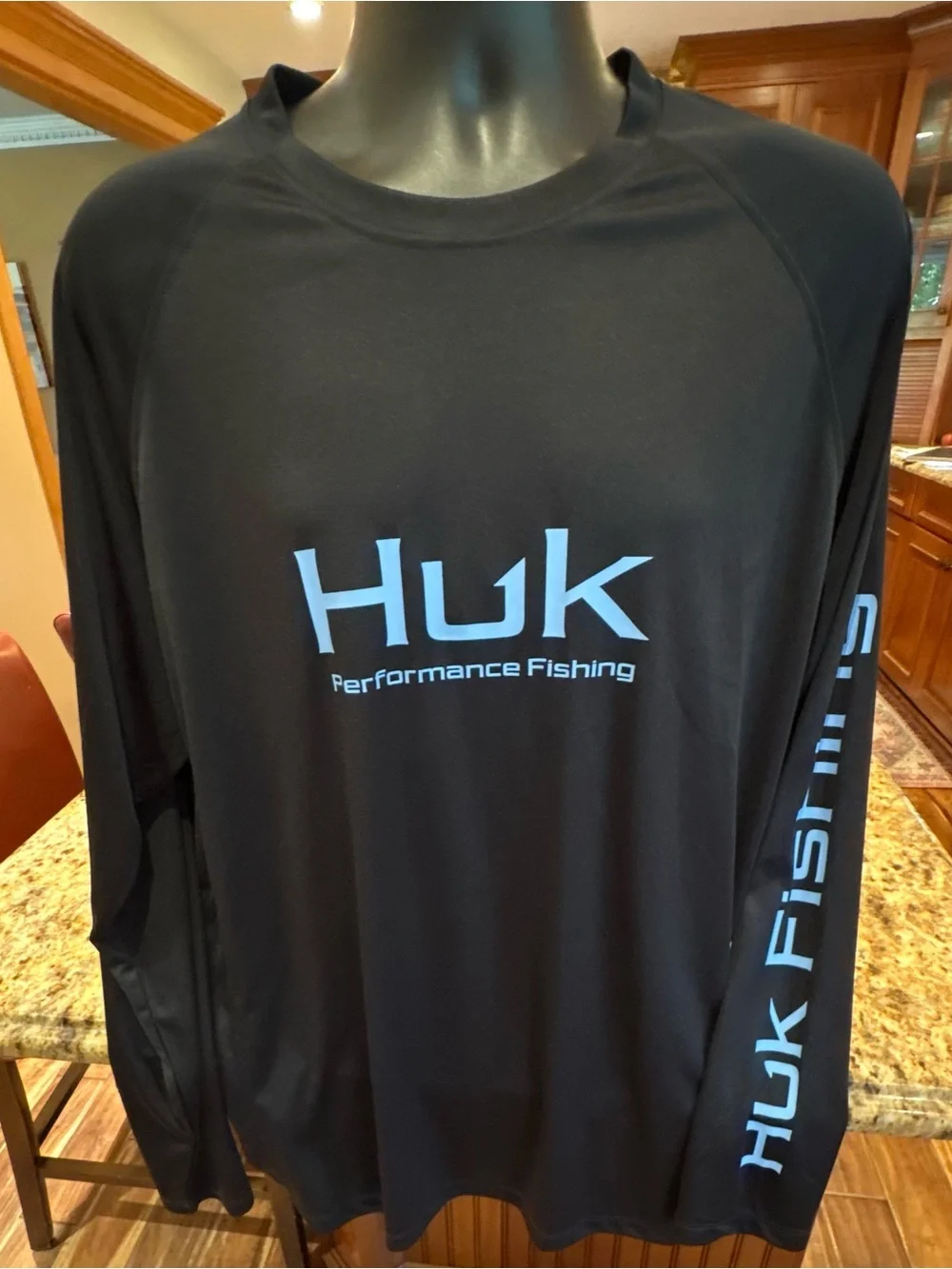 Huk men’s long sleeve performance Fishing Shirt. Sharp Black with blue logos.